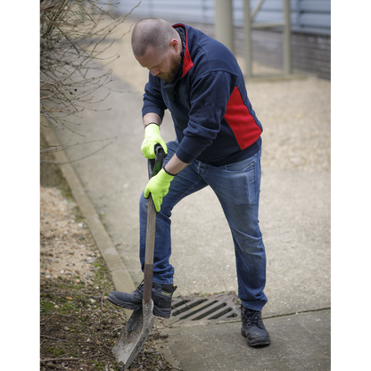 Person using a shovel on a sidewalk