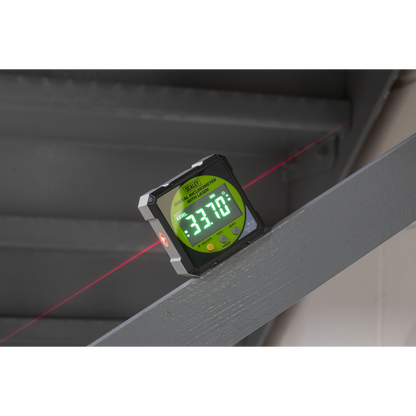 Digital laser level with red laser beam on a surface
